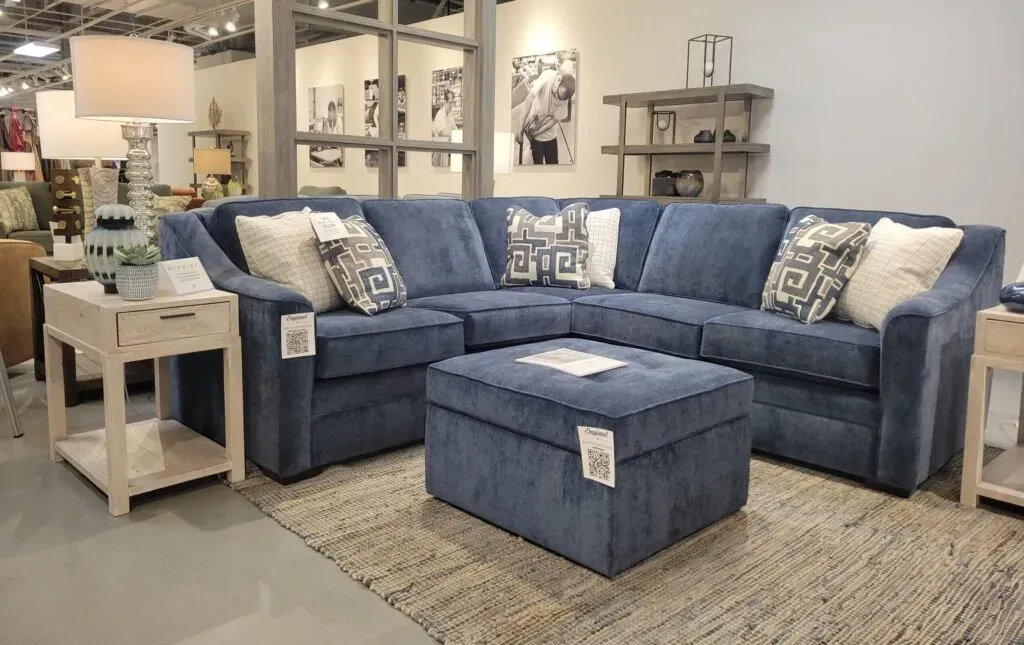 Blue sectional sofa and footrest in a showroom